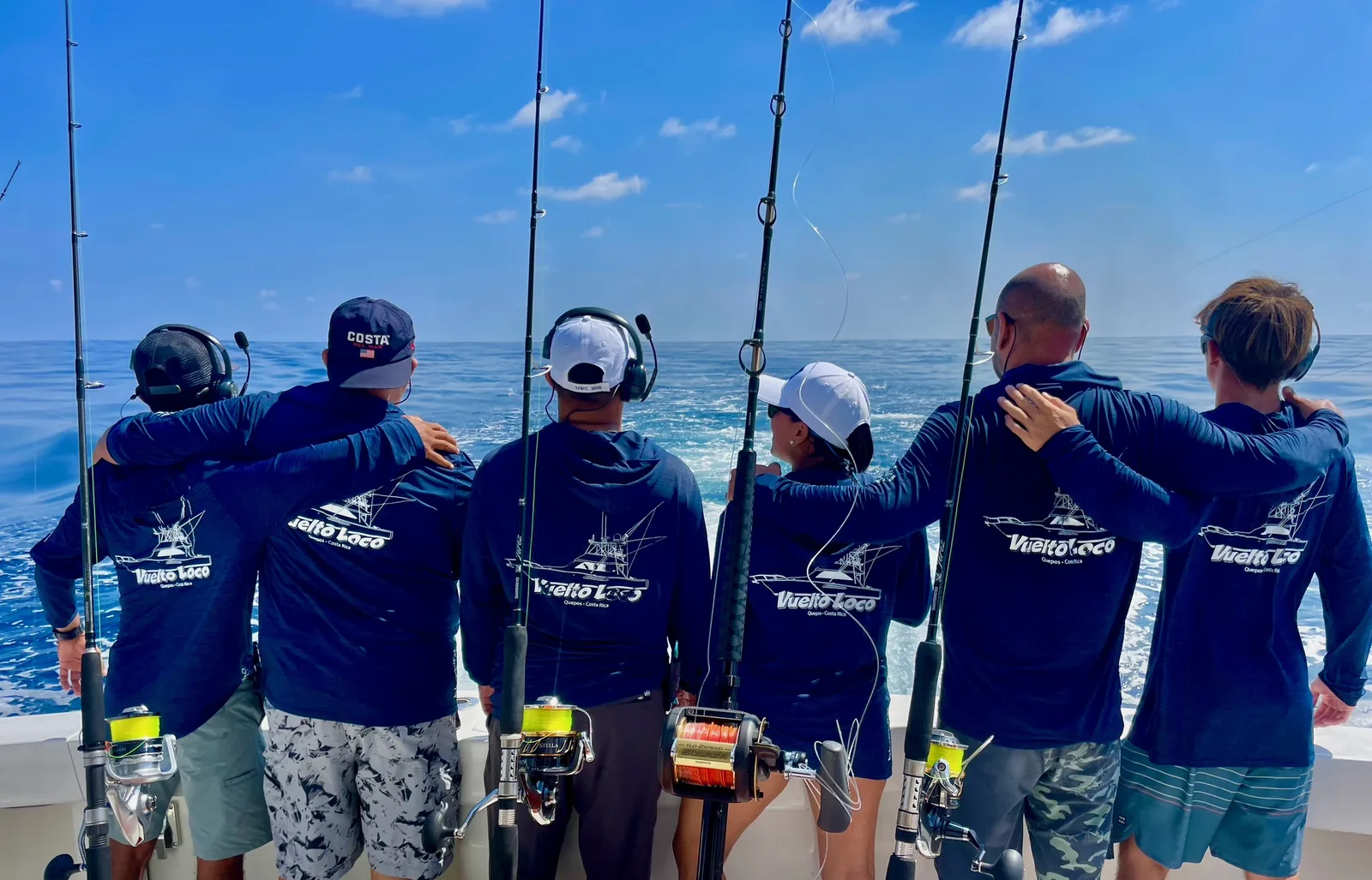 Anglers and crew with a full rod spread on the Vuelto Loco, horizon behind