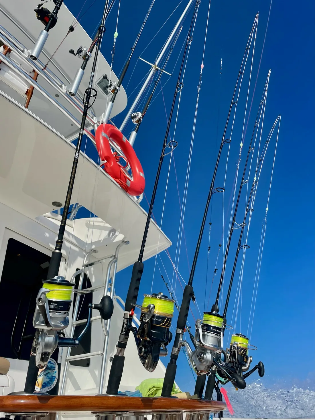Spinning reels racked aboard the Vuelto Loco, loaded with yellow braid for inshore work
